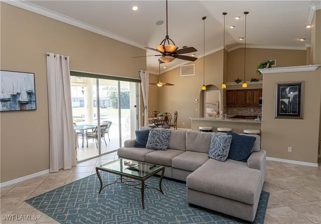 a living room with furniture and a chandelier