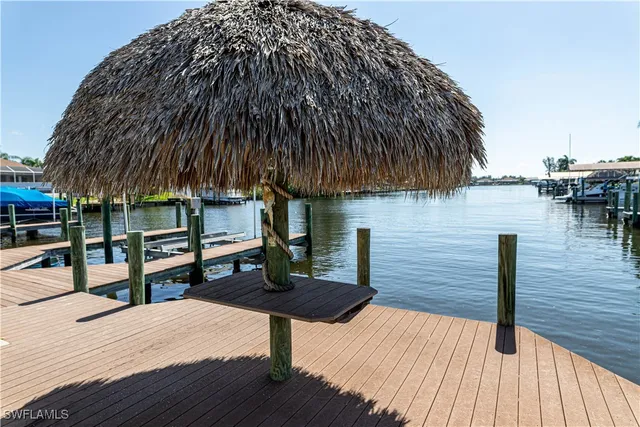 a backyard of a house with wooden floor and outdoor seating