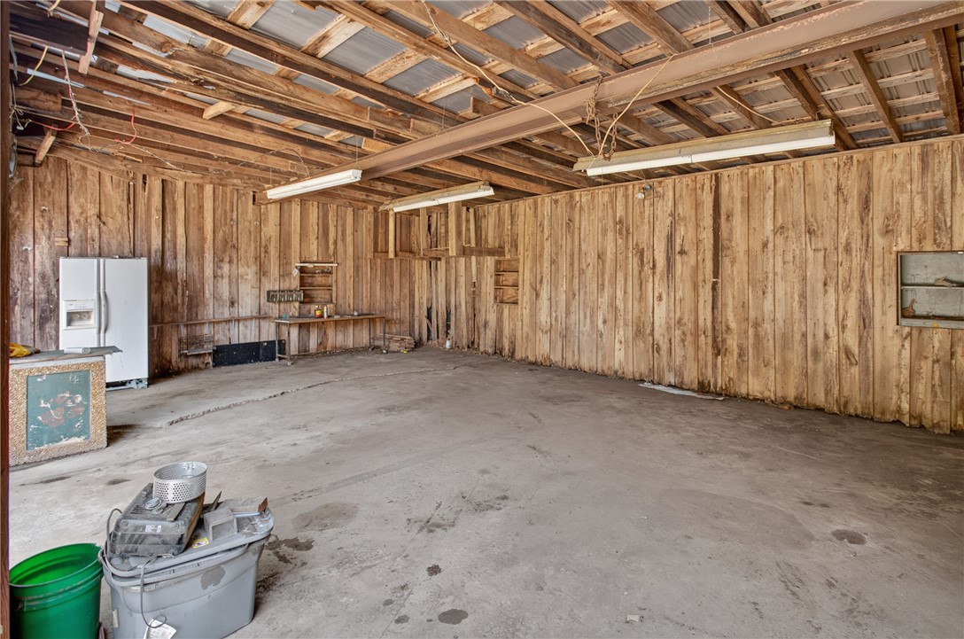 1719 Old Central Road Central, SC 29630 - Photo 13 of 45 An expansive wood-clad workshop features a durable concrete floor and sturdy overhead beams.