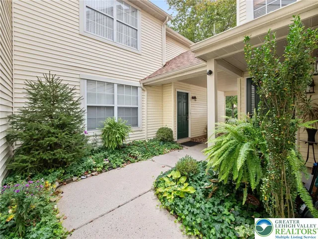 a front view of a house with a garden