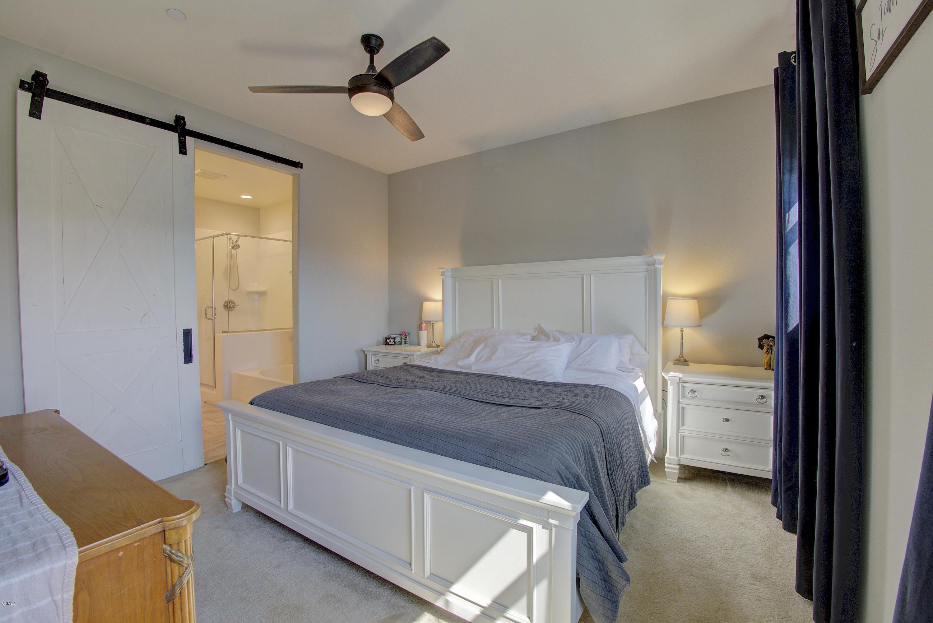178 Prairie Street Camarillo, CA 93010 - Photo 29 of 74 a bedroom with a bed and a chandelier