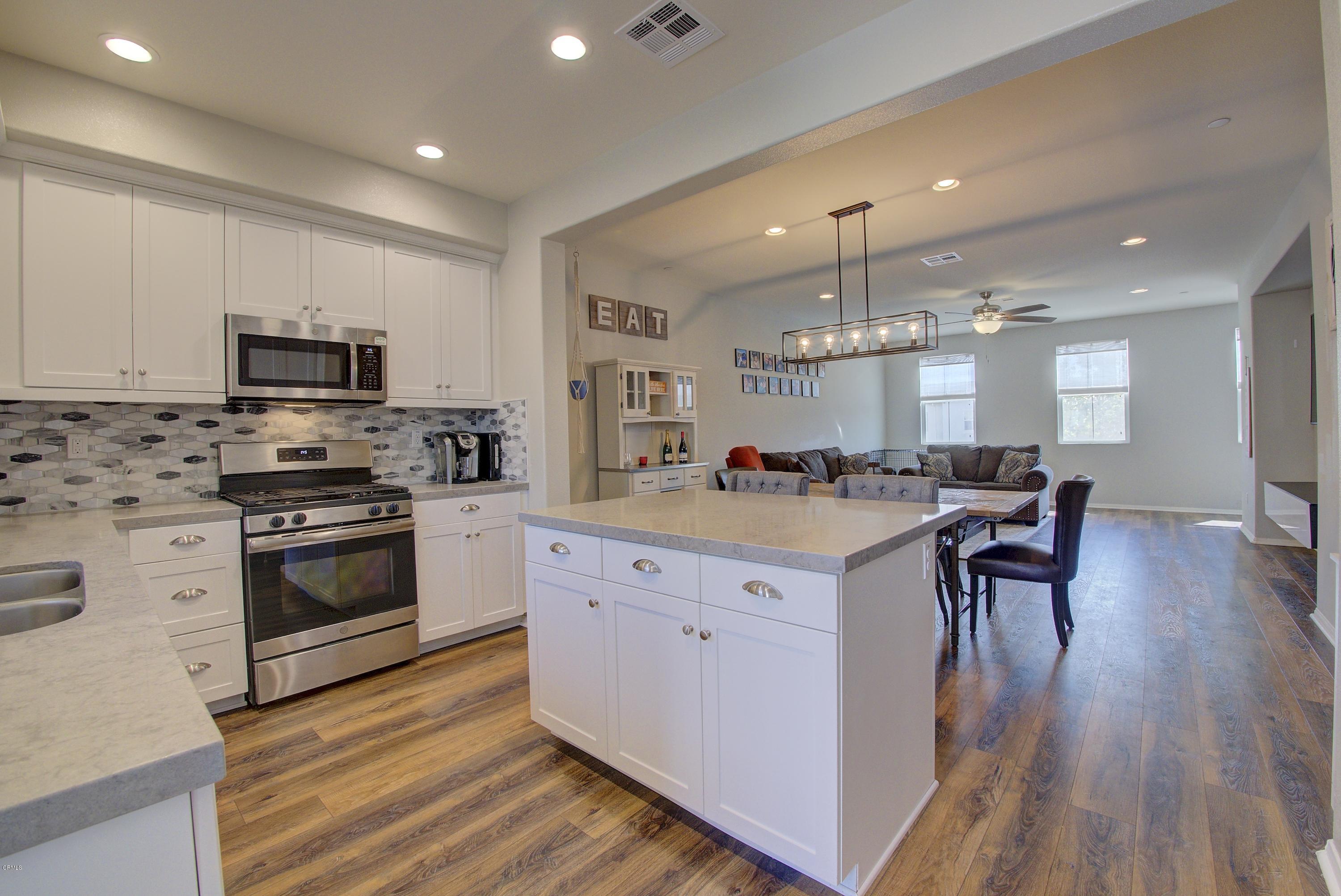 178 Prairie Street Camarillo, CA 93010 - Photo 6 of 74 a kitchen with a sink wooden floor and stainless steel appliances