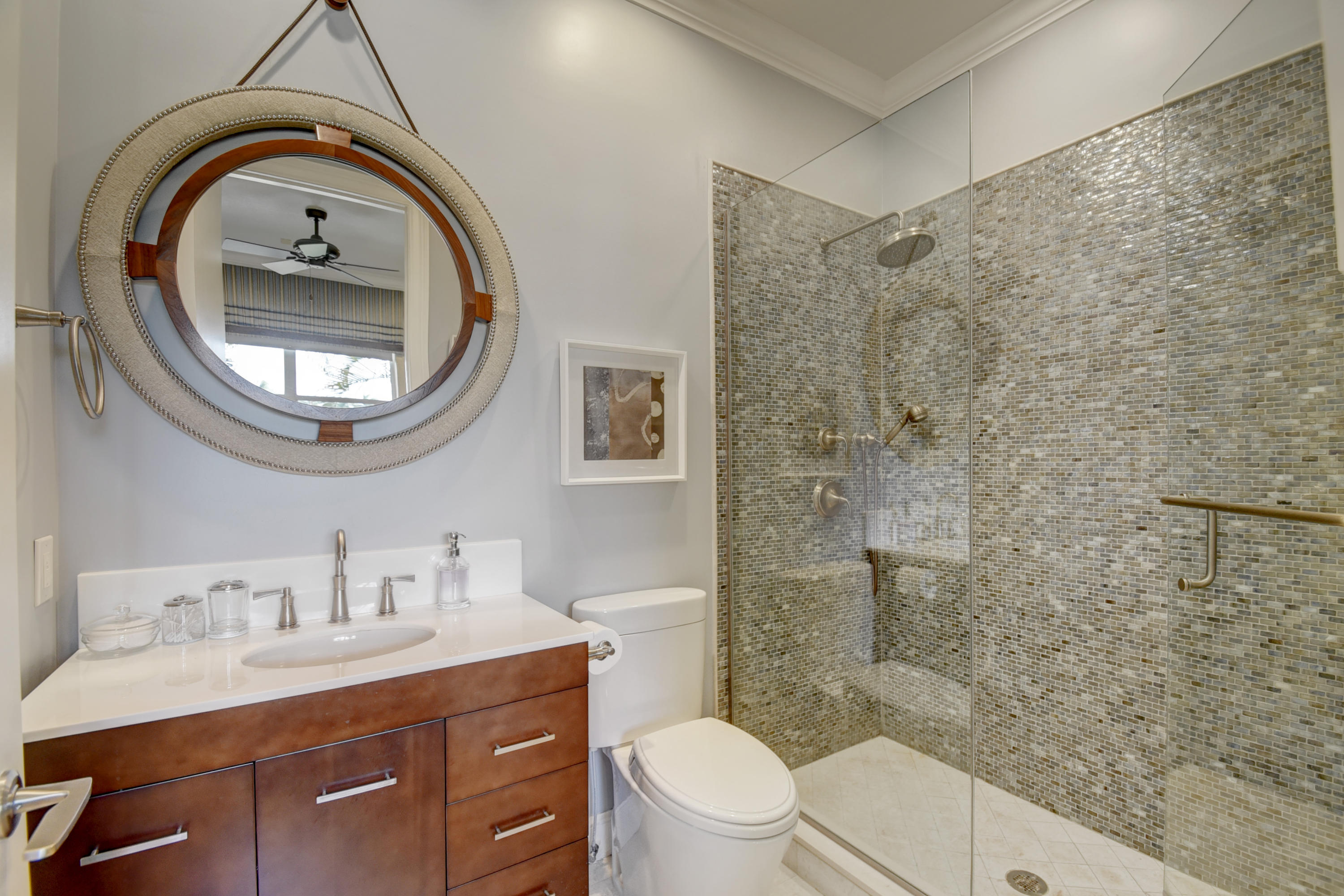 4191 Briarcliff Circle Boca Raton, FL 33496 - Photo 34 of 37 a bathroom with a toilet a sink a mirror a vanity and shower