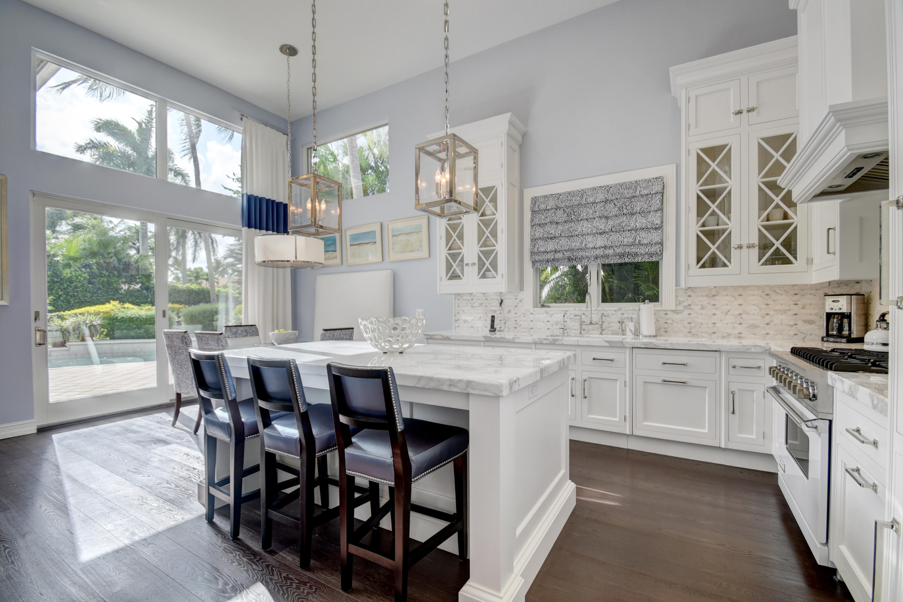 4191 Briarcliff Circle Boca Raton, FL 33496 - Photo 7 of 37 a kitchen with stainless steel appliances granite countertop a kitchen island a stove a table and chairs in it