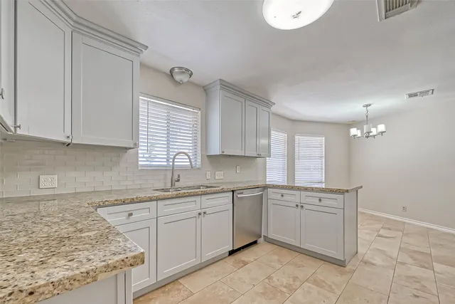a kitchen with a sink window and cabinets