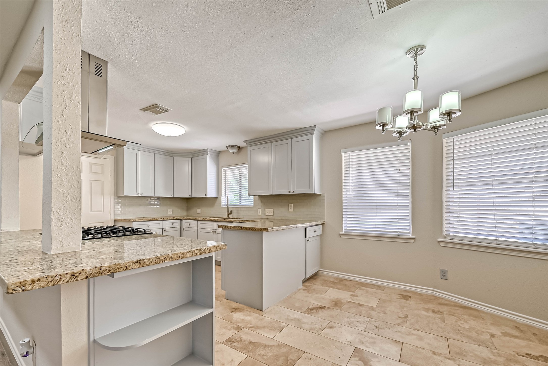 9707 Kit Street Houston, TX 77096 - Photo 19 of 45 a kitchen that has a lot of cabinets in it and a window