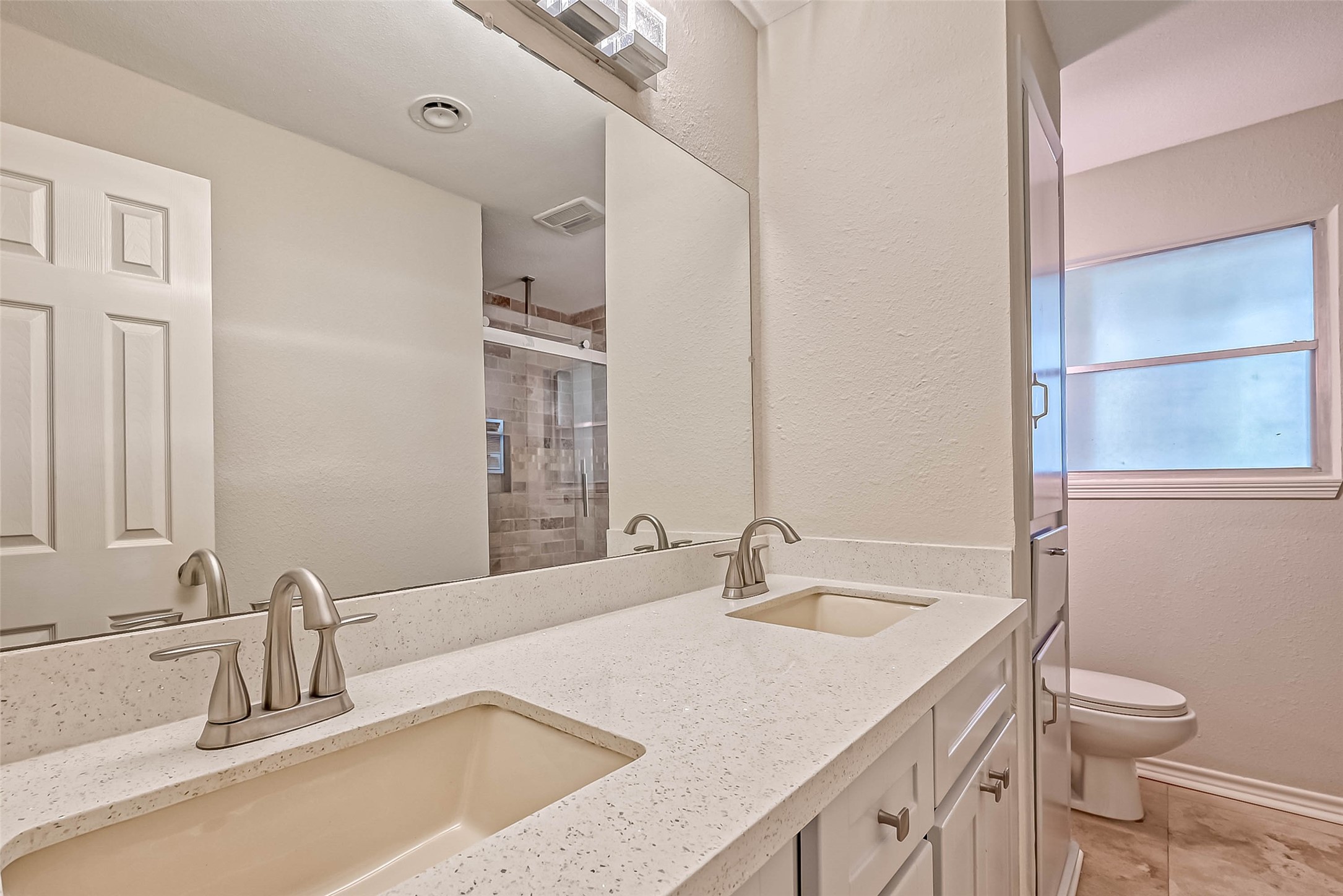 9707 Kit Street Houston, TX 77096 - Photo 21 of 45 a bathroom with a granite countertop sink and a toilet
