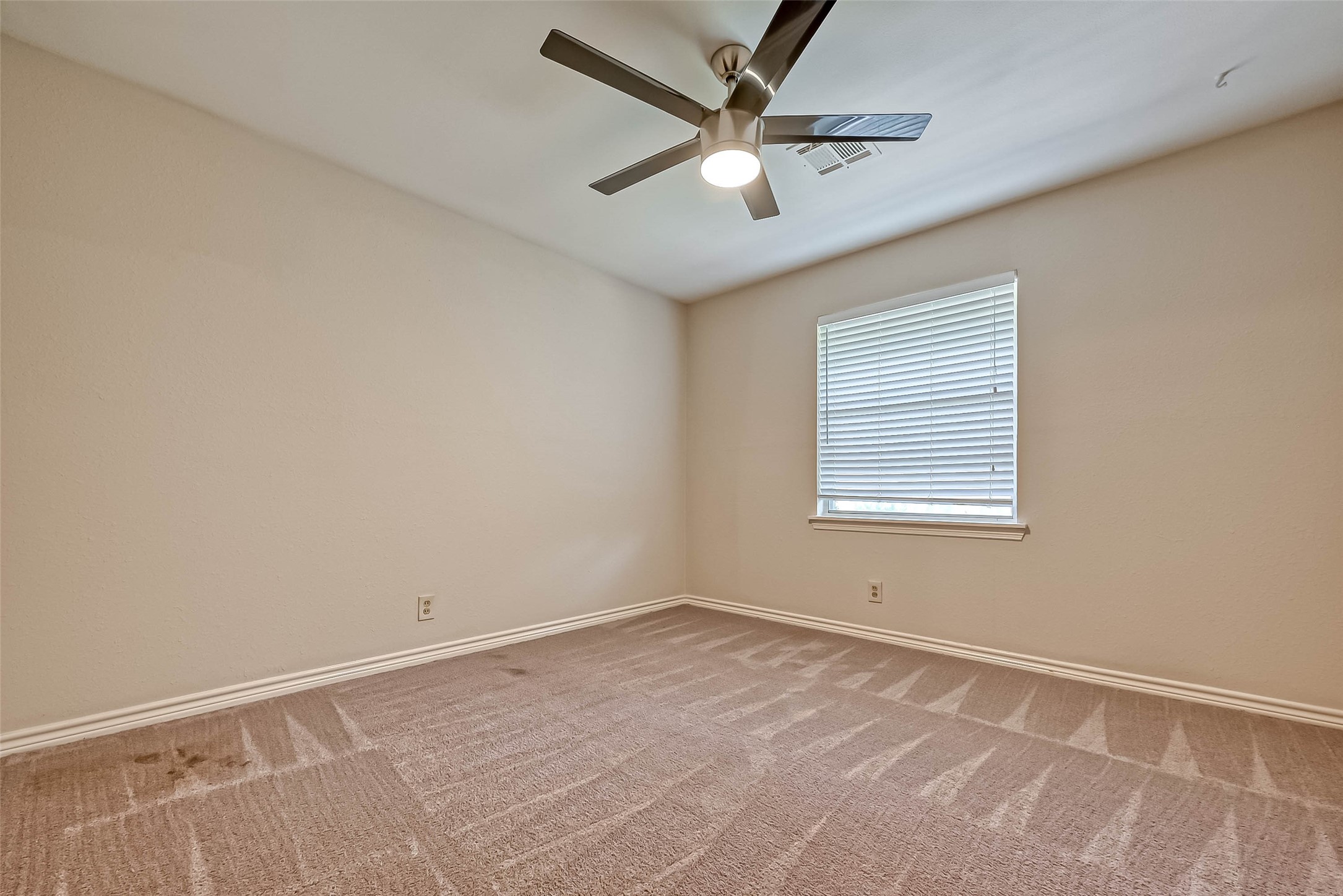 9707 Kit Street Houston, TX 77096 - Photo 22 of 45 an empty room with a window and a fan