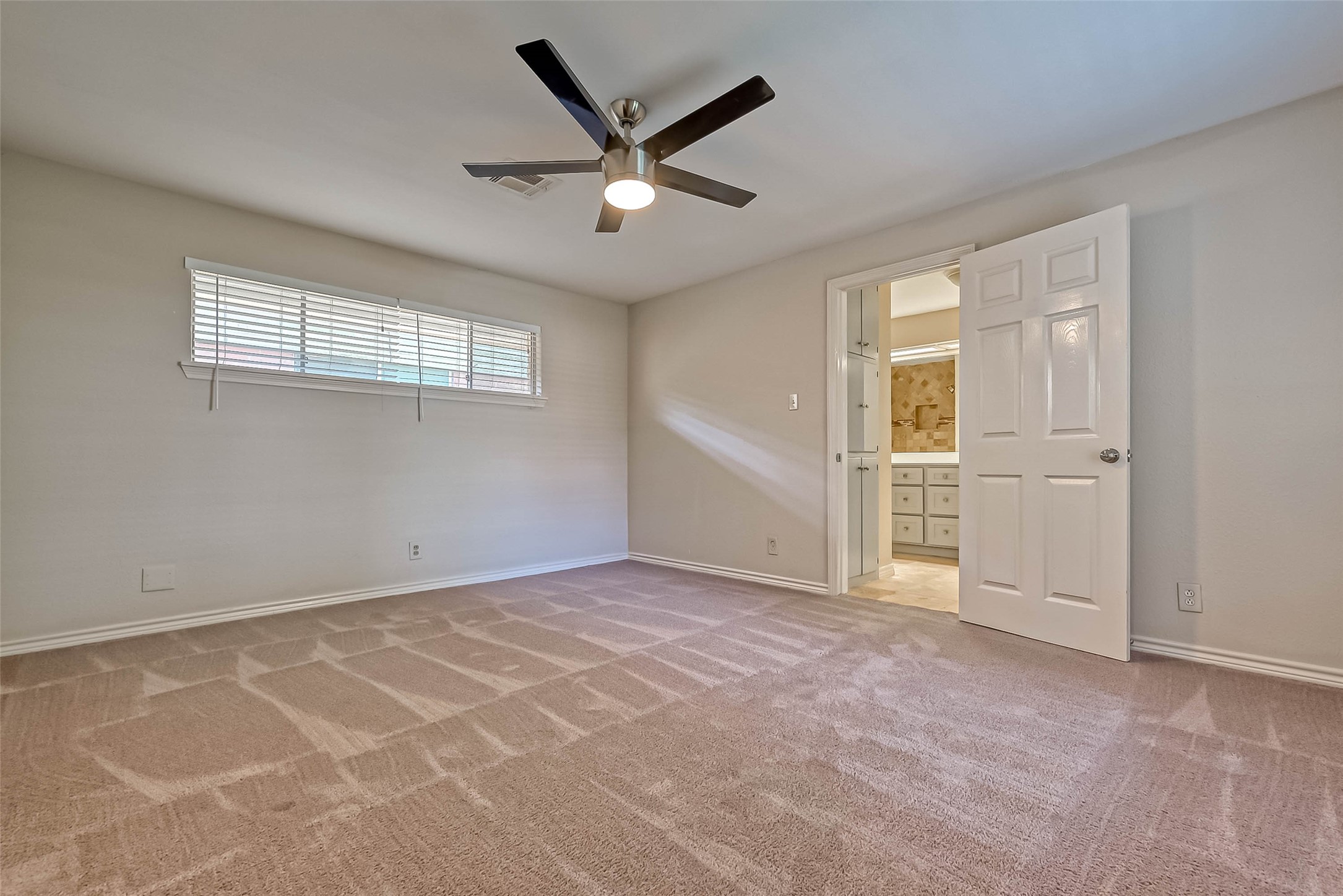 9707 Kit Street Houston, TX 77096 - Photo 30 of 45 an empty room with windows and ceiling fan