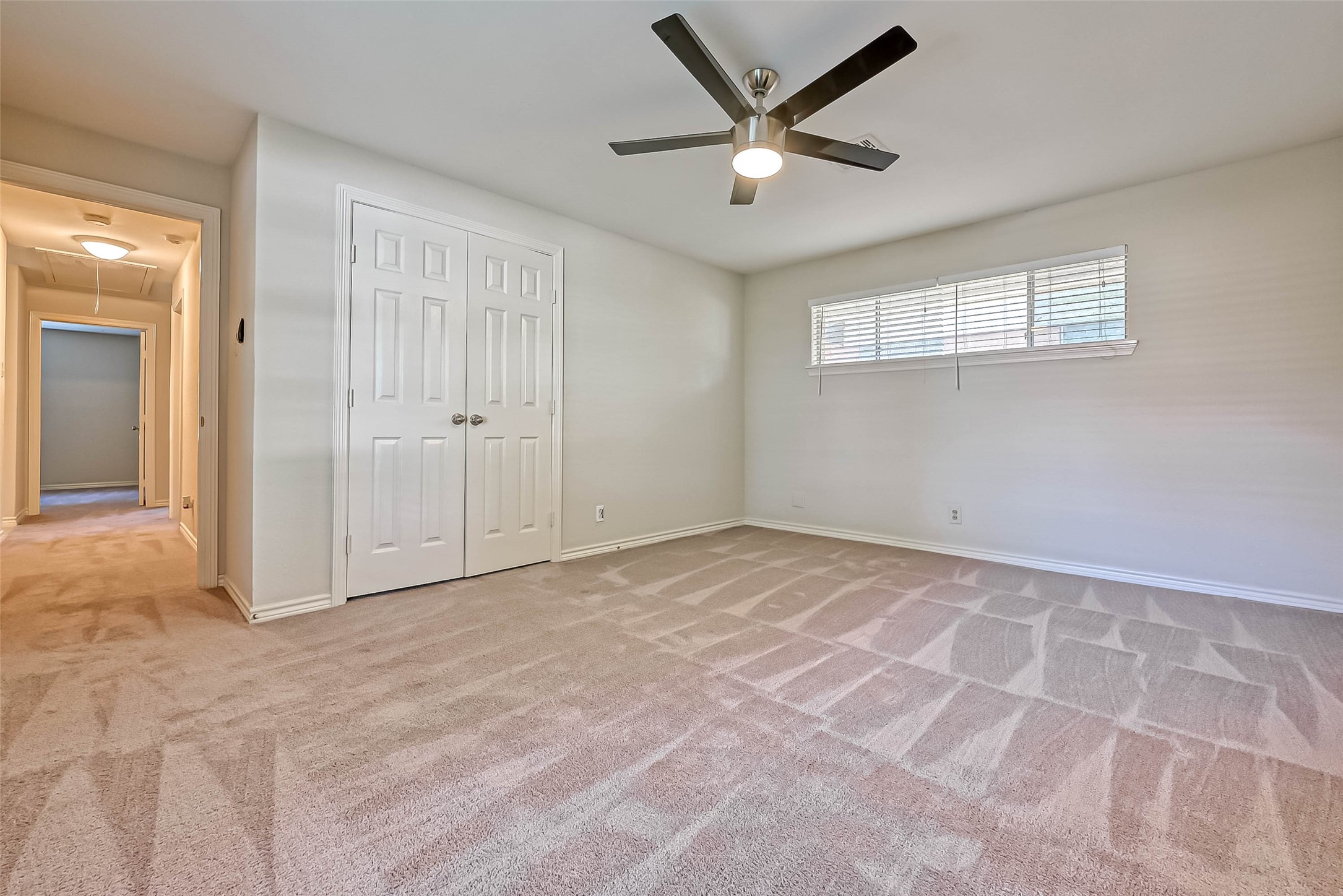 9707 Kit Street Houston, TX 77096 - Photo 31 of 45 an empty room with a ceiling fan and a window