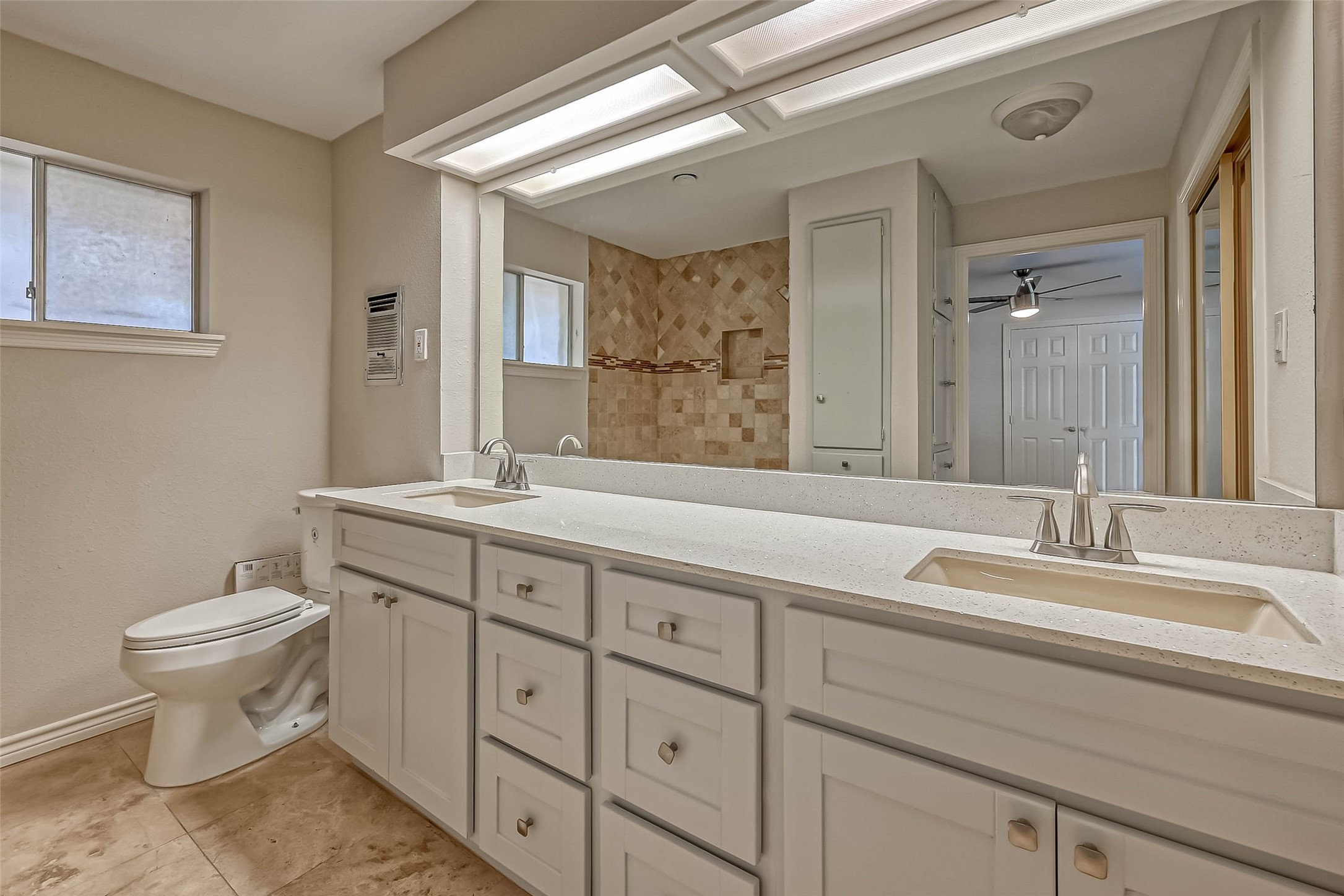 9707 Kit Street Houston, TX 77096 - Photo 33 of 45 a bathroom with a double vanity sink toilet and a mirror