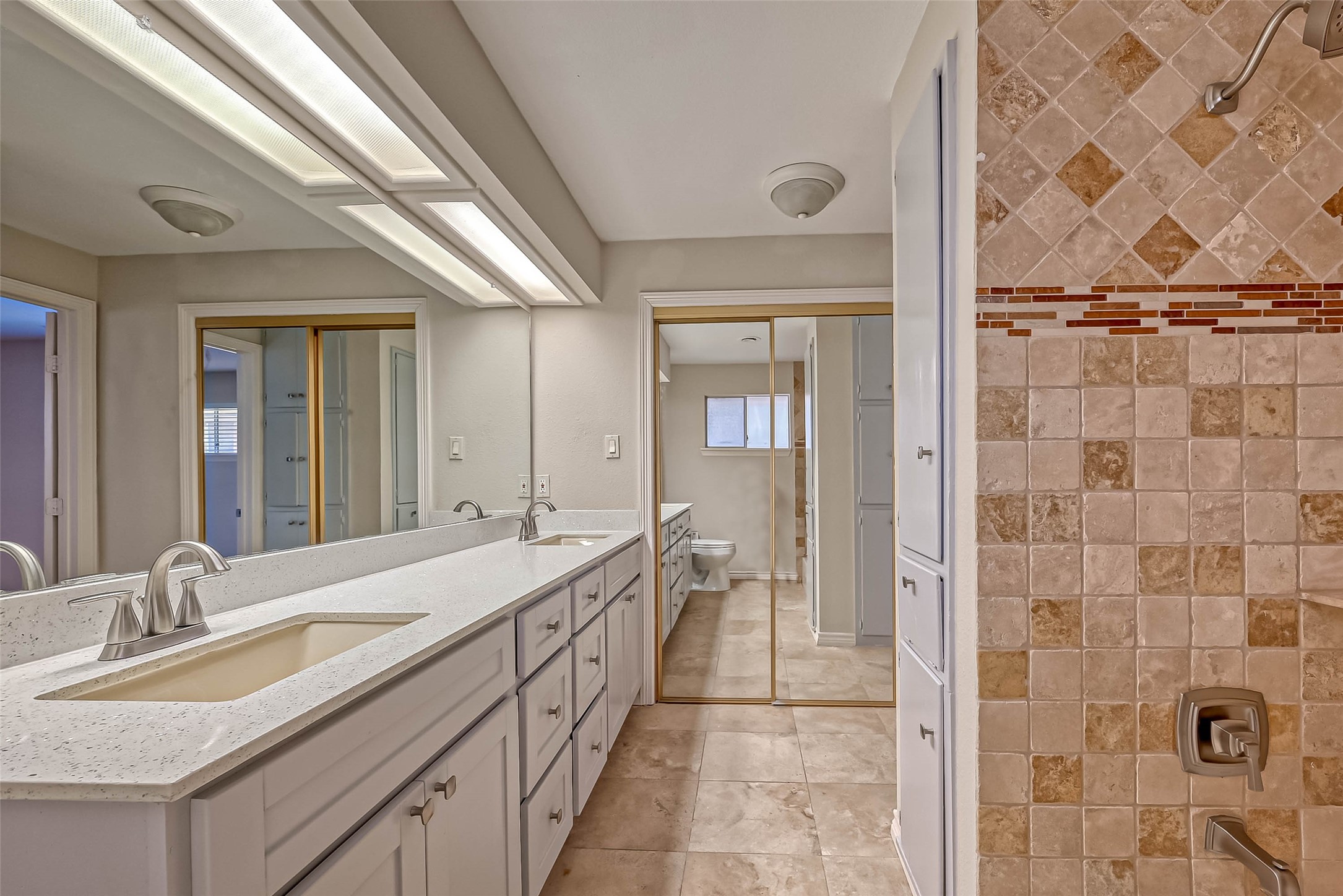 9707 Kit Street Houston, TX 77096 - Photo 35 of 45 a spacious bathroom with a double vanity sink a mirror and a shower