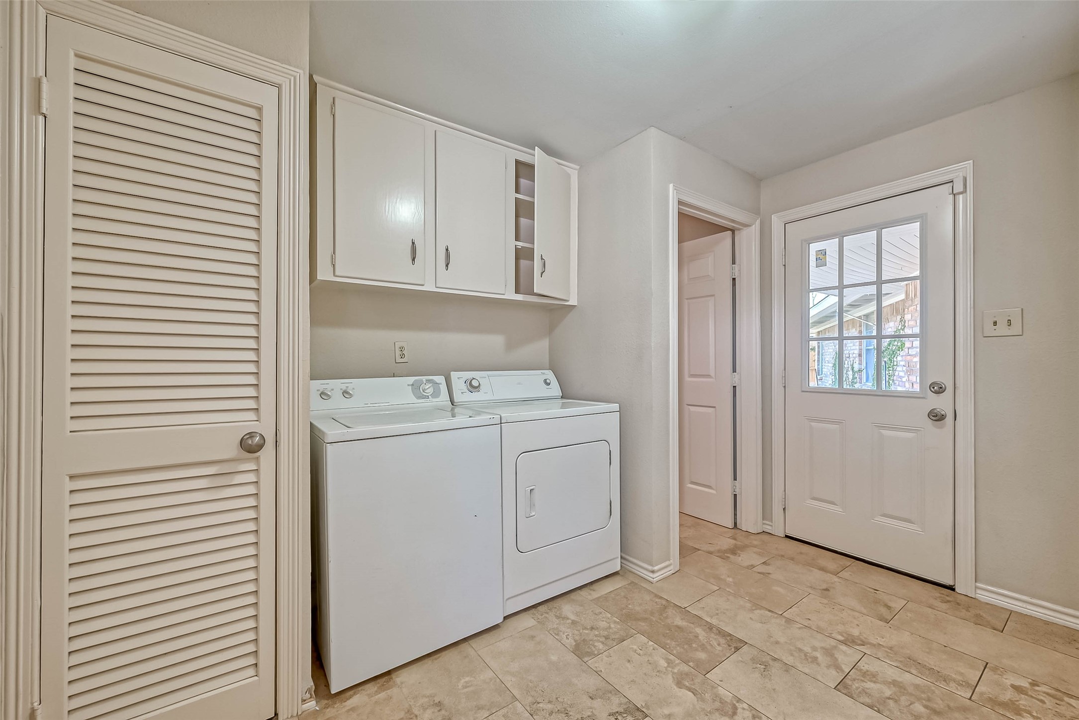 9707 Kit Street Houston, TX 77096 - Photo 36 of 45 a view of a storage & utility room with closet wooden floor and windows
