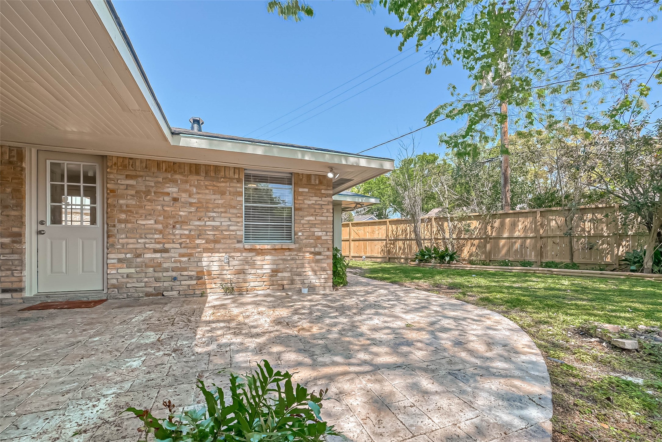 9707 Kit Street Houston, TX 77096 - Photo 39 of 45 a view of a backyard with wooden fence and large trees