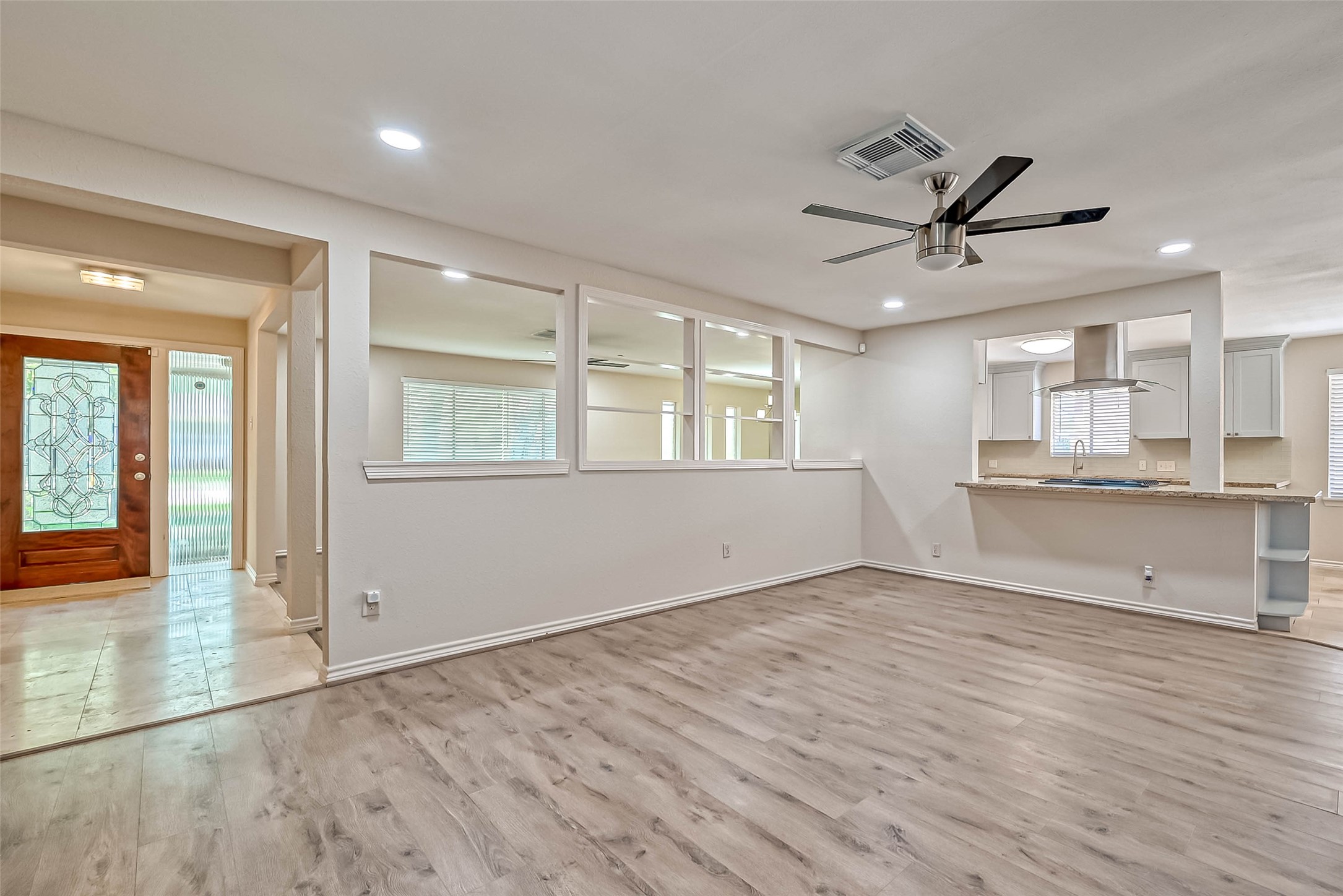 9707 Kit Street Houston, TX 77096 - Photo 7 of 45 an empty room with wooden floor and windows