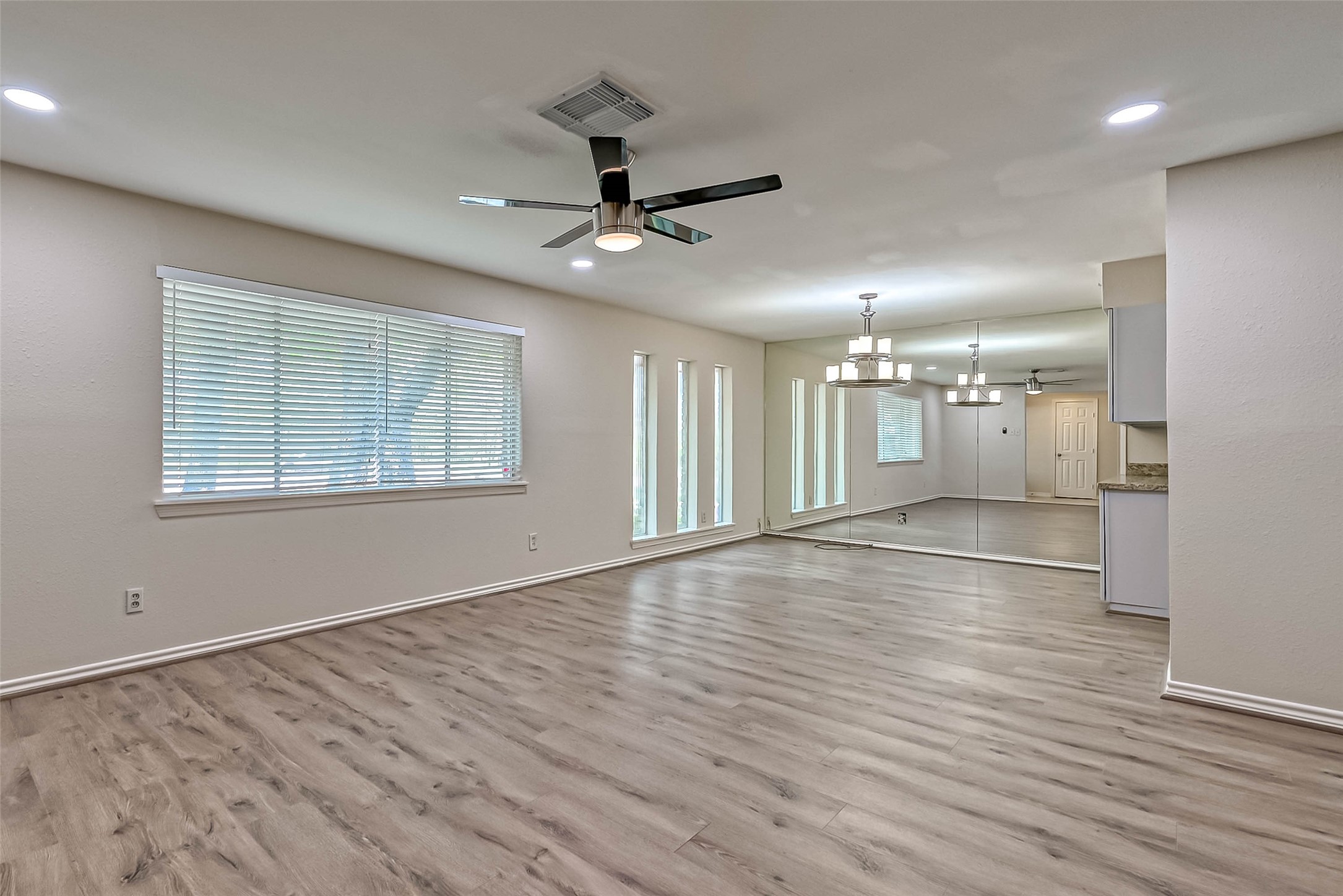 9707 Kit Street Houston, TX 77096 - Photo 9 of 45 a view of empty room with wooden floor and fan