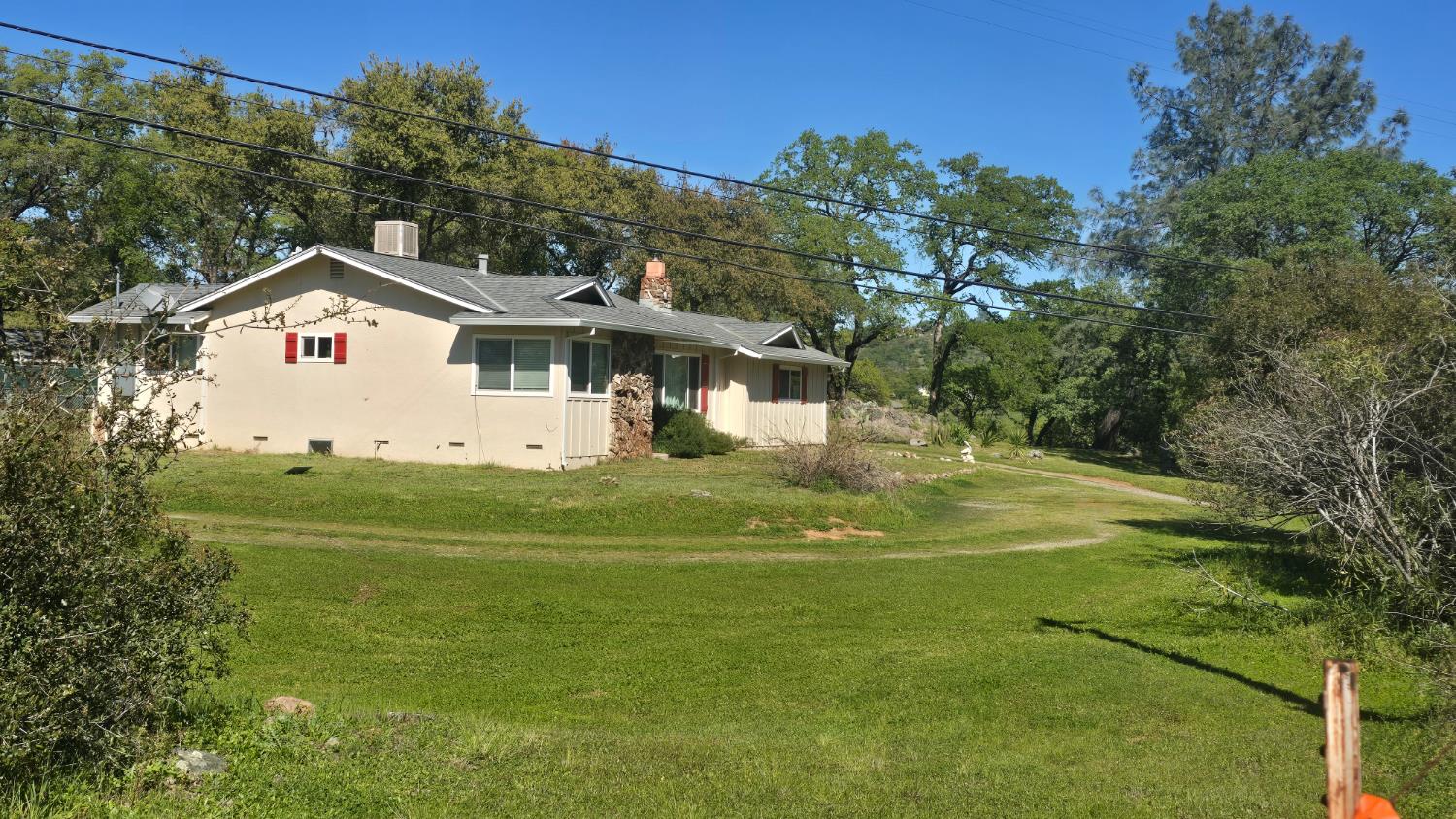 11592 Peoria Road Browns Valley, CA 95918 - Photo 20 of 49 a view of a white house with a big yard and large trees