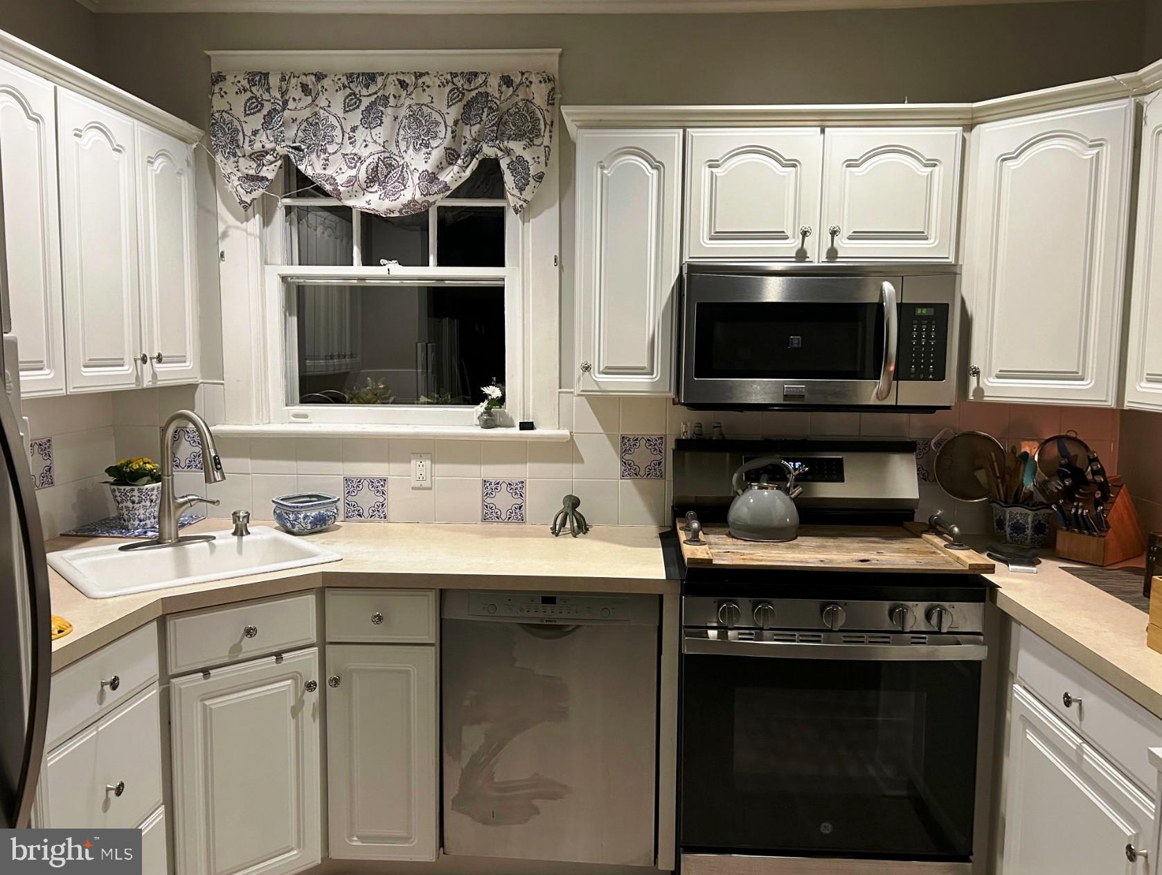715 North Easton Road Glenside, PA 19038 - Photo 53 of 59 a kitchen with stainless steel appliances a stove sink and microwave