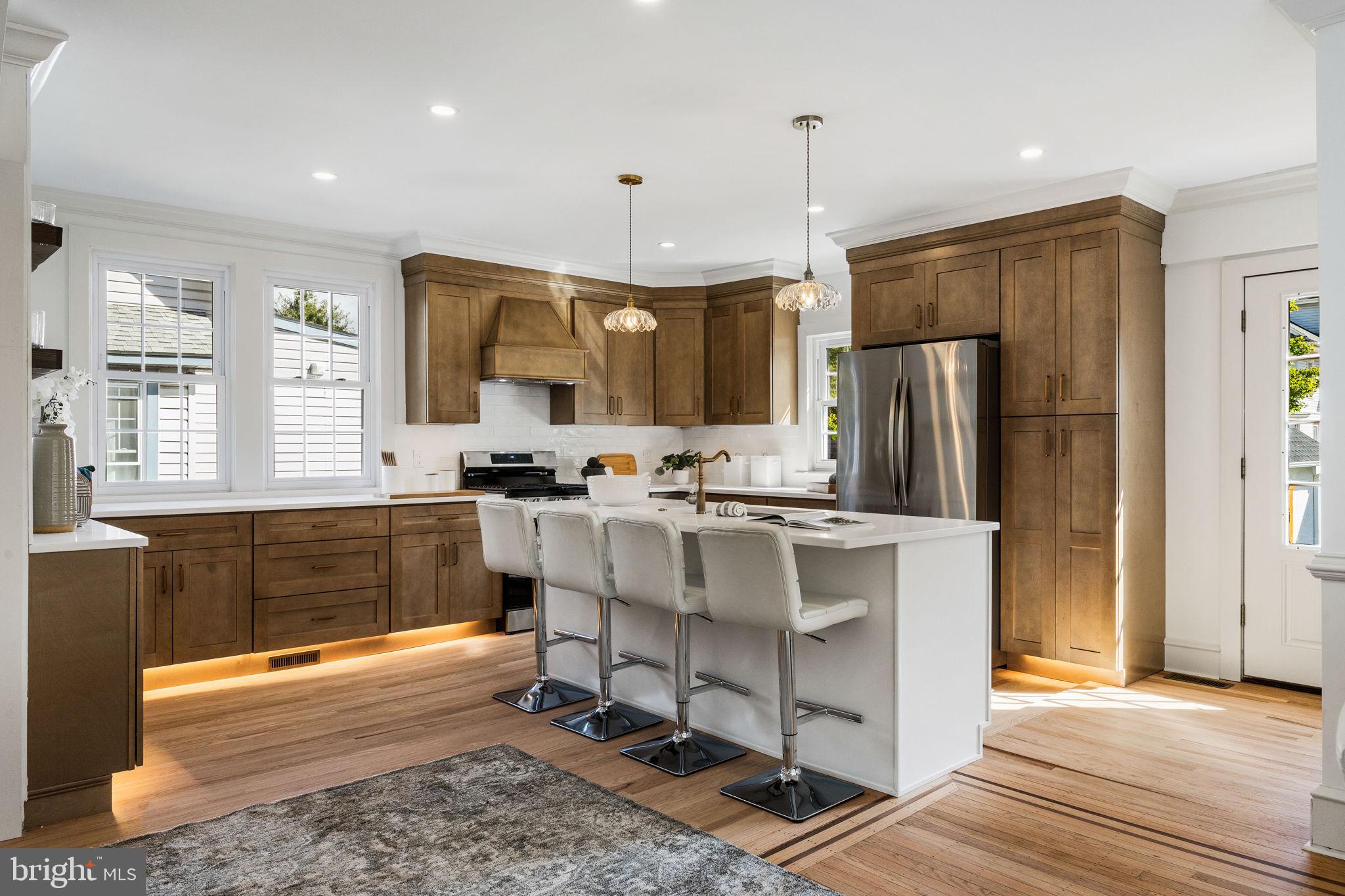 13 Princeton Road Havertown, PA 19083 - Photo 25 of 73 a kitchen with kitchen island granite countertop a refrigerator a stove top oven a sink and cabinets