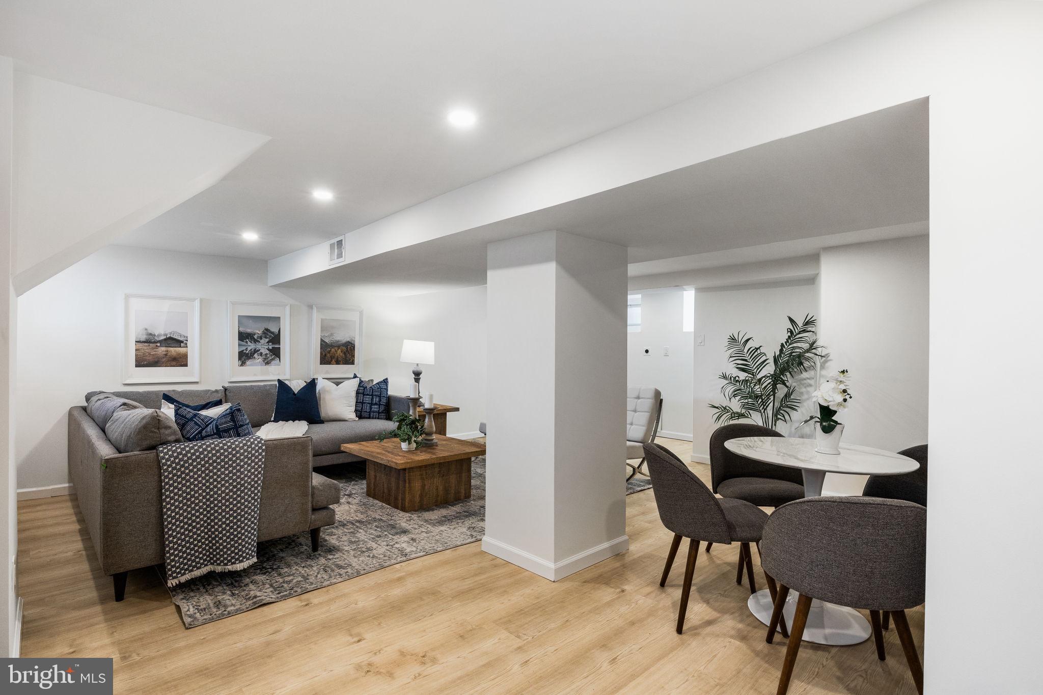 13 Princeton Road Havertown, PA 19083 - Photo 59 of 73 a living room with furniture and a dining room with wooden floor