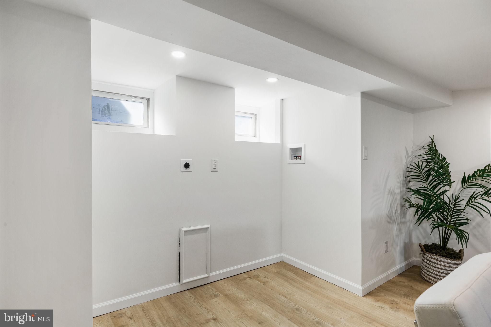 13 Princeton Road Havertown, PA 19083 - Photo 63 of 73 a view of a hallway with wooden floor and a potted plant