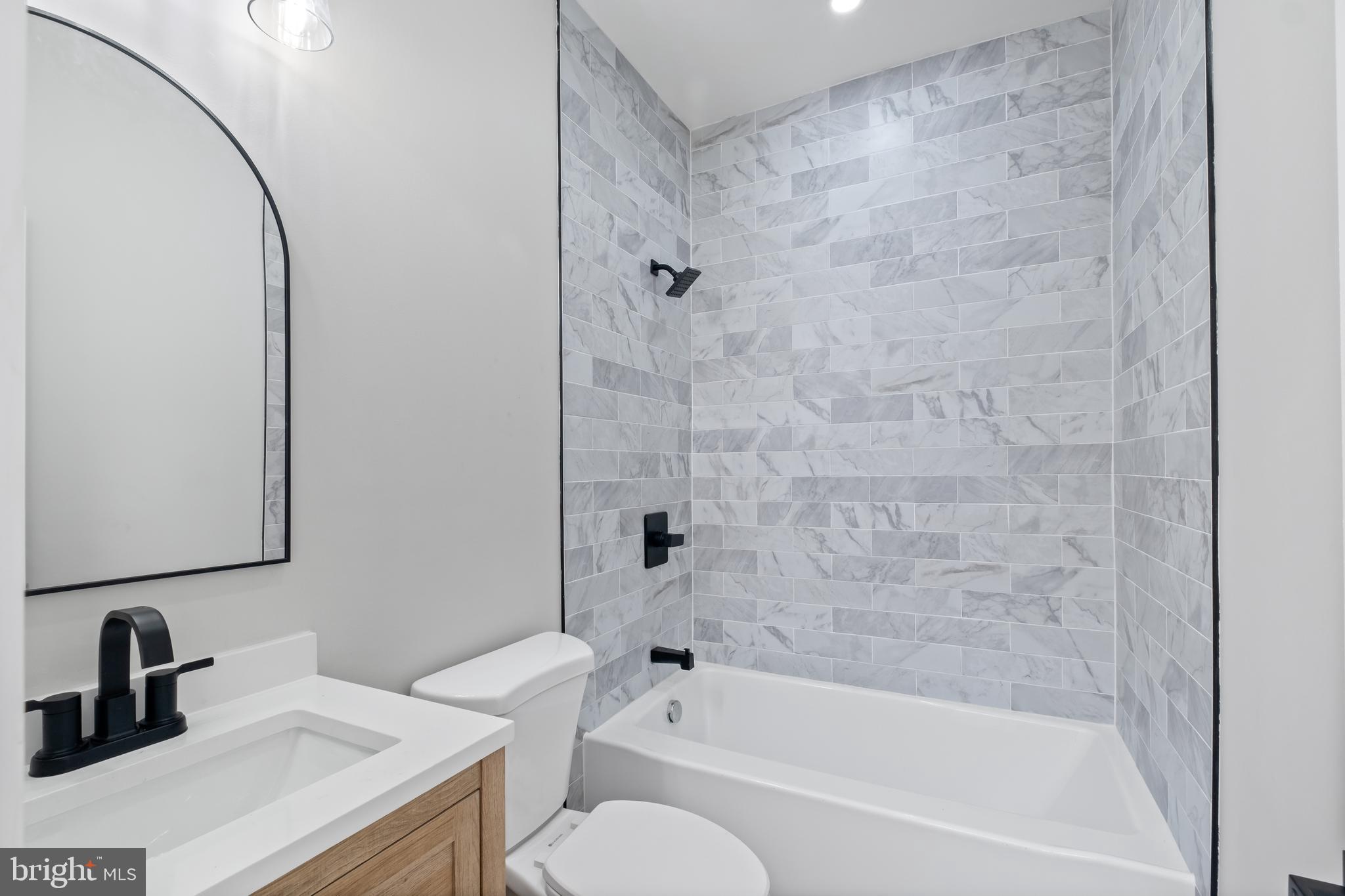 35 Michigan Avenue Northeast Washington, DC 20002 - Photo 13 of 28 a bathroom with a sink toilet a mirror and shower