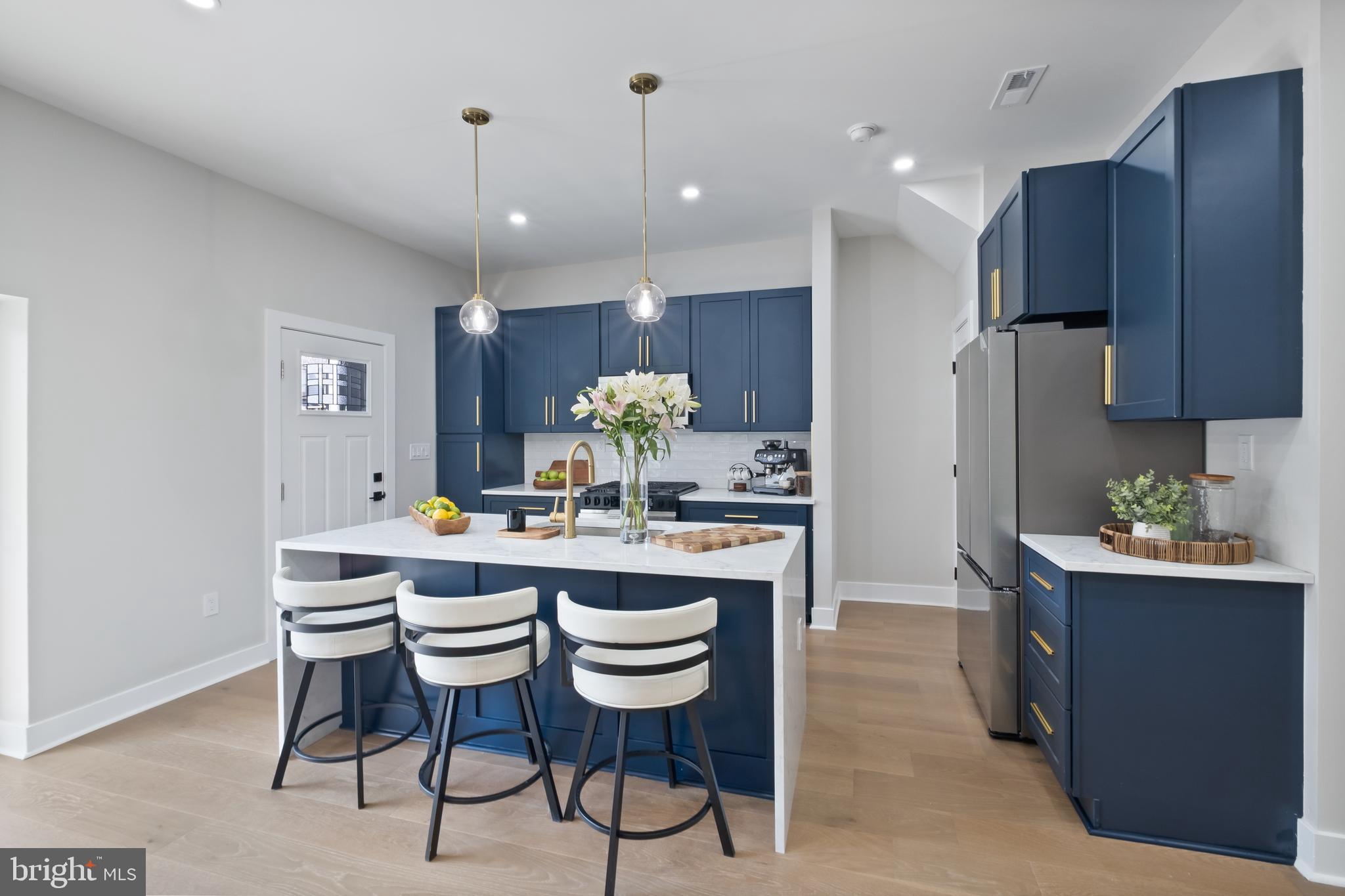 35 Michigan Avenue Northeast Washington, DC 20002 - Photo 4 of 28 a kitchen with kitchen island granite countertop wooden cabinets and chairs