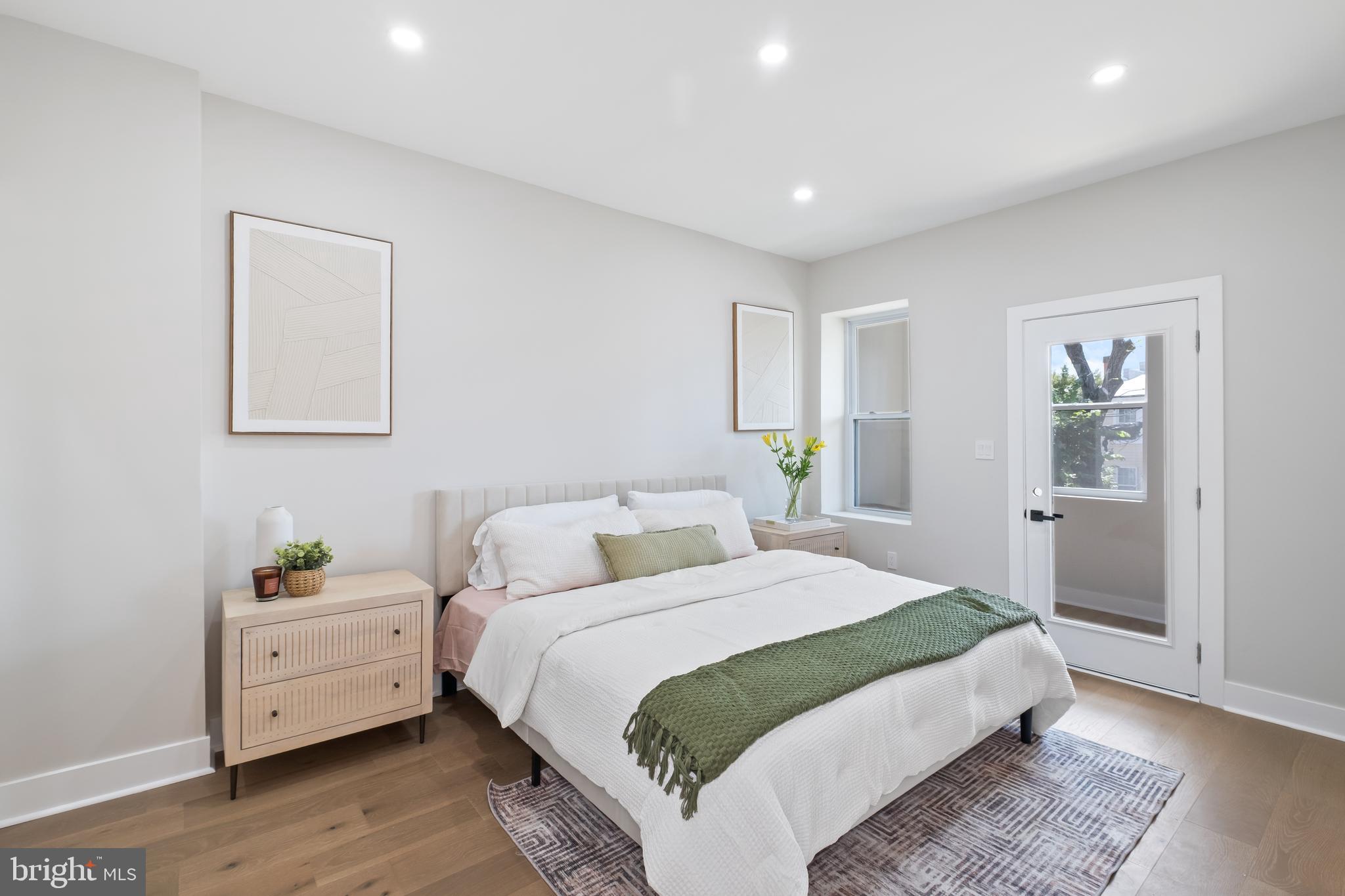 35 Michigan Avenue Northeast Washington, DC 20002 - Photo 8 of 28 a bedroom with a bed and wooden floor