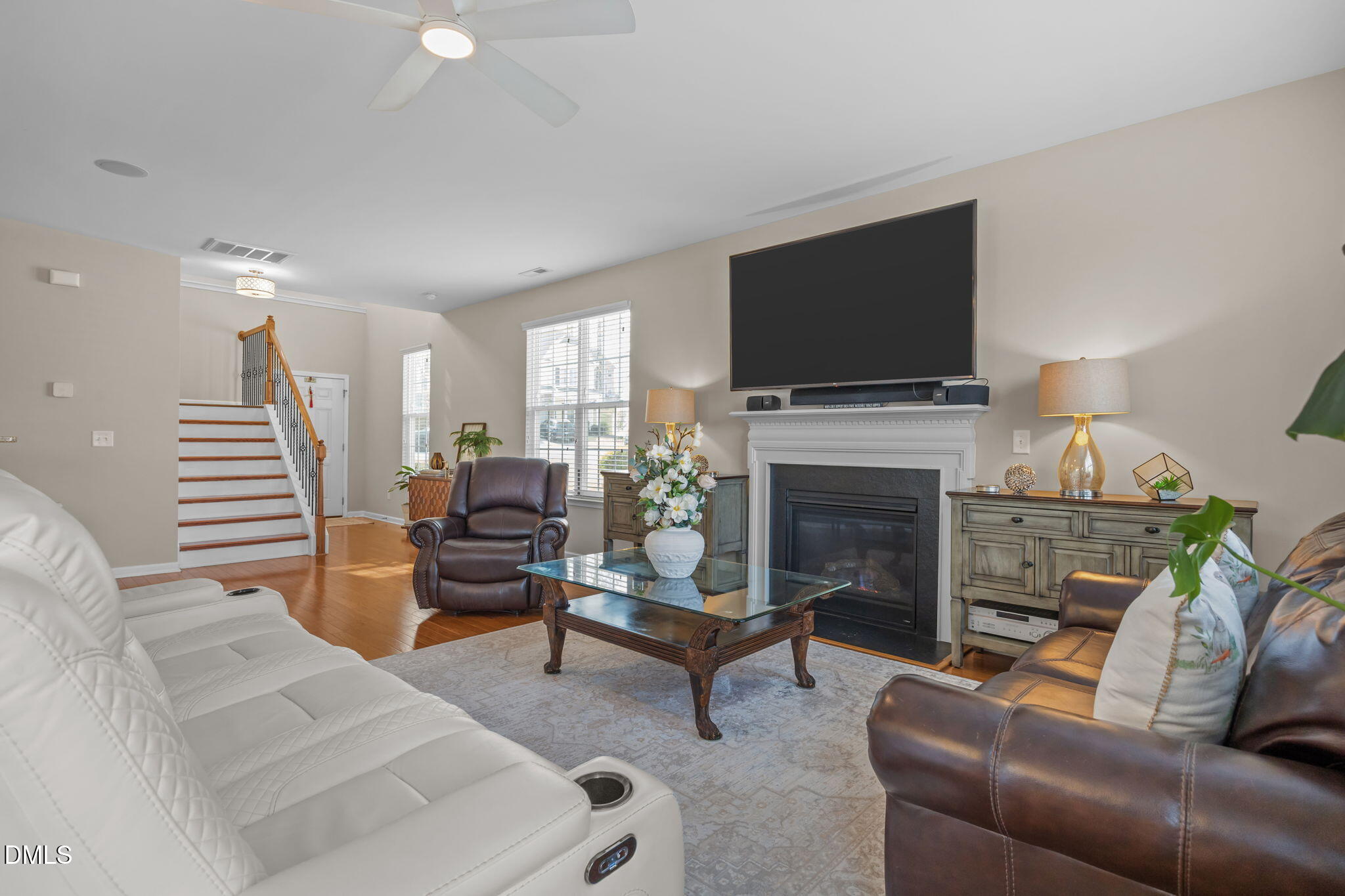 5049 Jelynn Street Raleigh, NC 27616 - Photo 6 of 33 a living room with furniture a flat screen tv and a fireplace