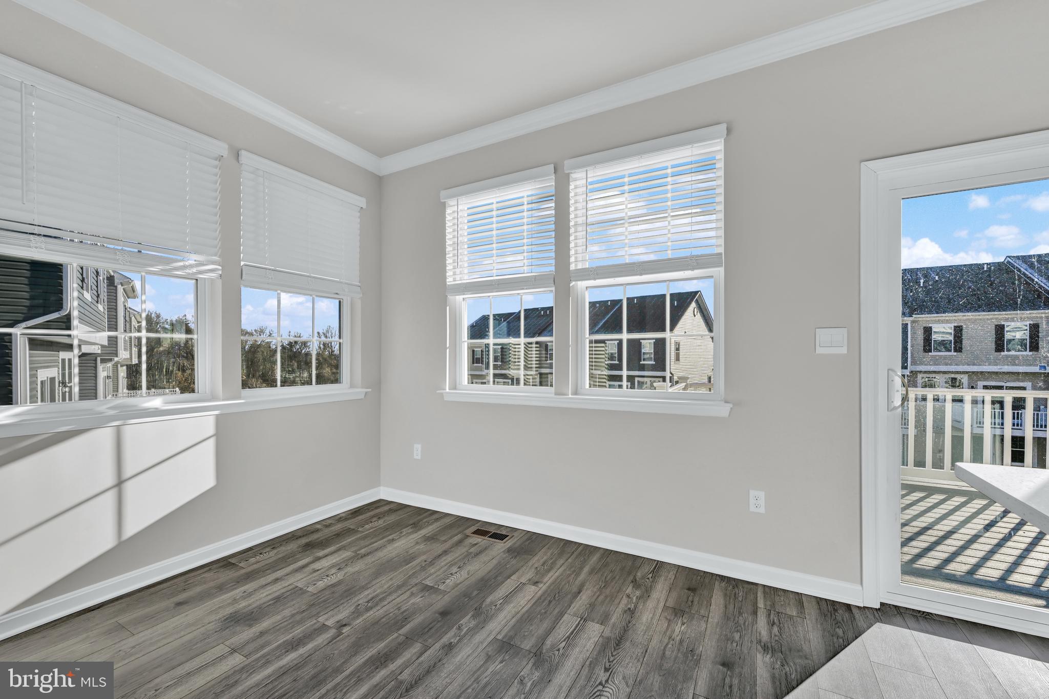 32 Merion Avenue Baltimore, MD 21237 - Photo 11 of 24 a view of an empty room with wooden floor and a window
