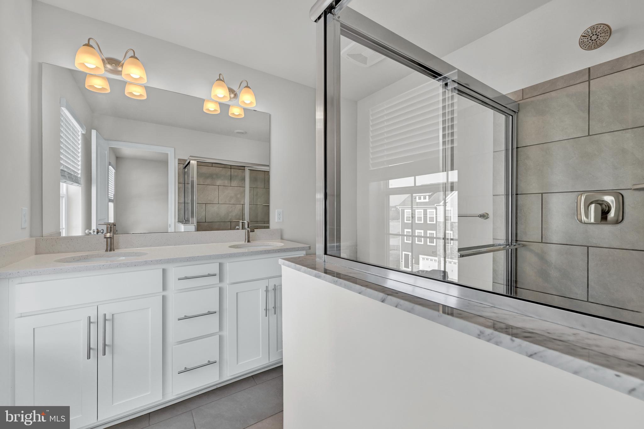 32 Merion Avenue Baltimore, MD 21237 - Photo 17 of 24 a bathroom with a sink and a large mirror