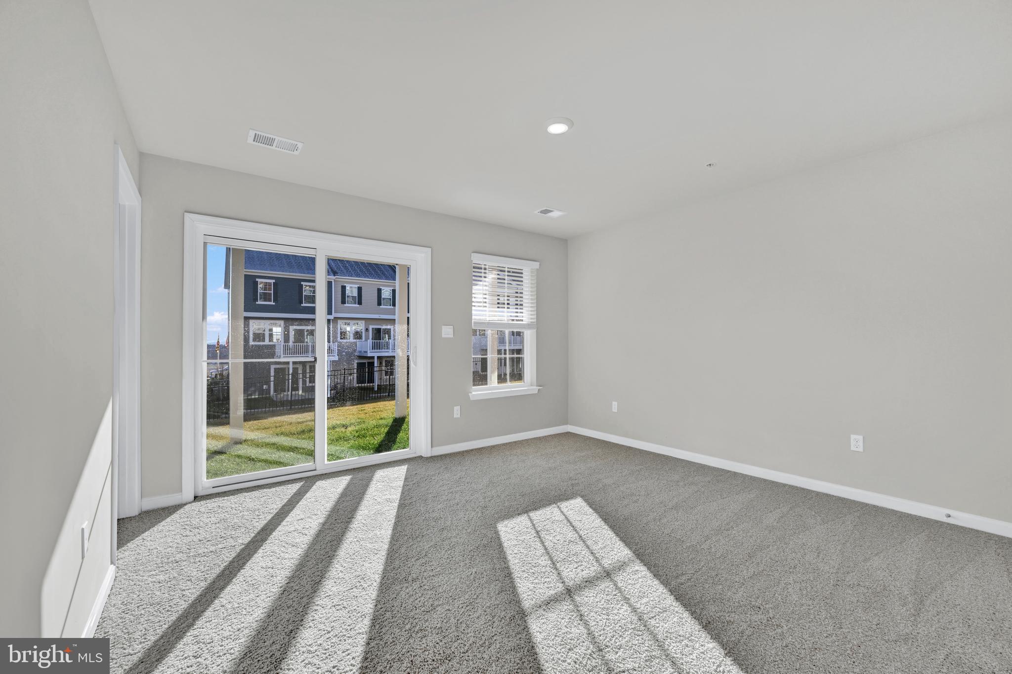 32 Merion Avenue Baltimore, MD 21237 - Photo 21 of 24 a view of an empty room with wooden floor and a window