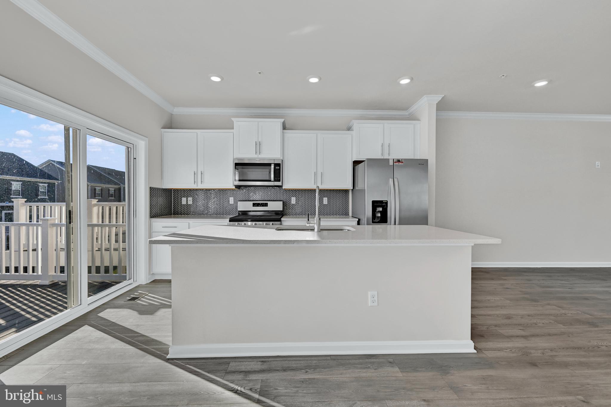 32 Merion Avenue Baltimore, MD 21237 - Photo 6 of 24 a view of kitchen with stainless steel appliances refrigerator sink microwave and cabinets