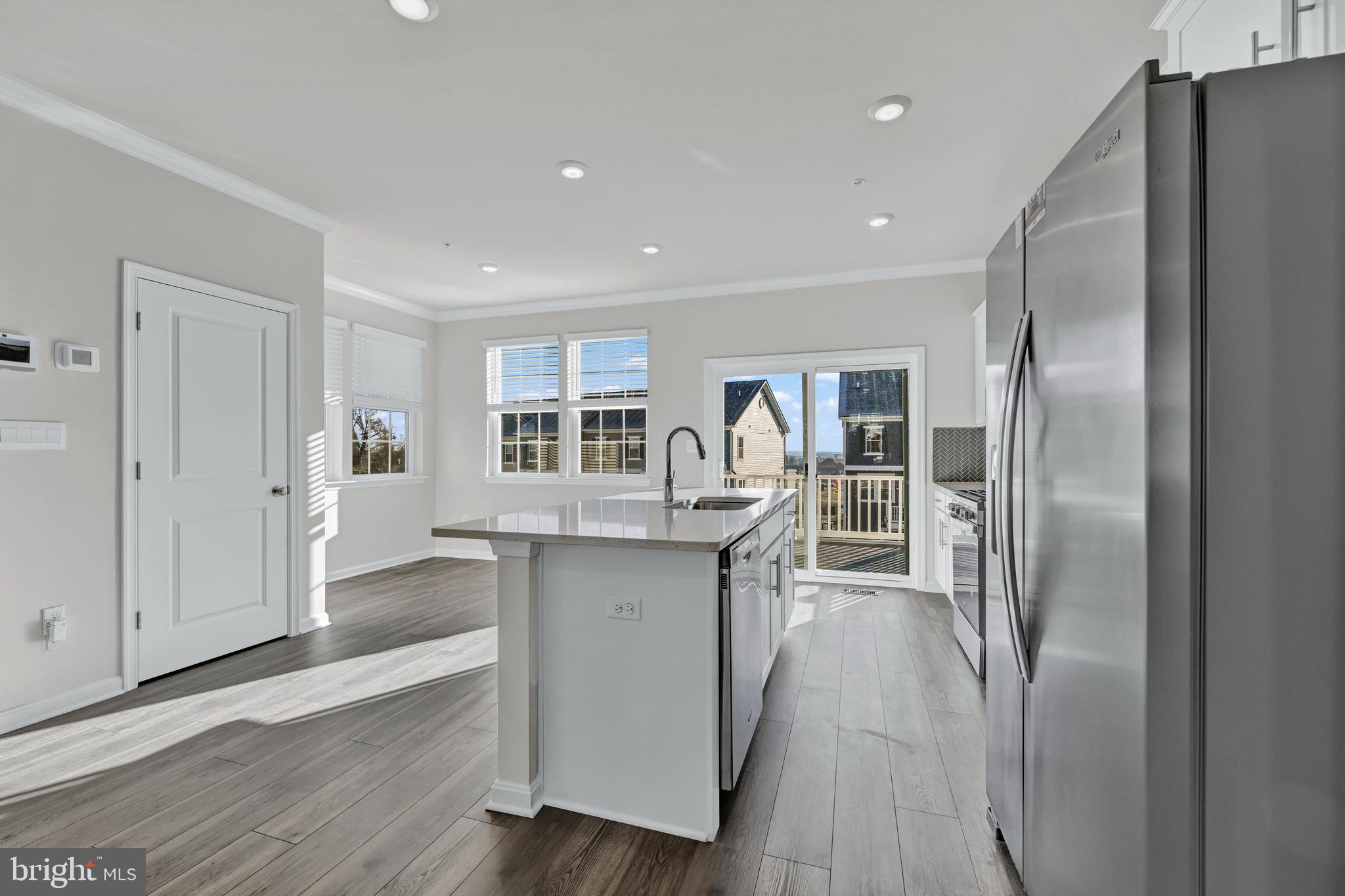 32 Merion Avenue Baltimore, MD 21237 - Photo 7 of 24 a kitchen with stainless steel appliances granite countertop a refrigerator and a sink