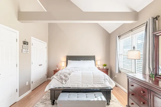 a bed sitting in a bedroom next to a window
