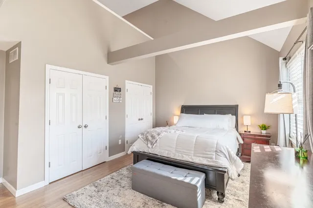 a bedroom with a bed and a lamp on table