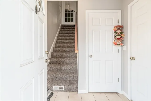 a view of a hallway with wooden floor and entryway
