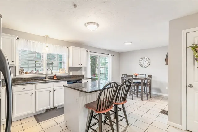 a kitchen with granite countertop a sink and cabinets