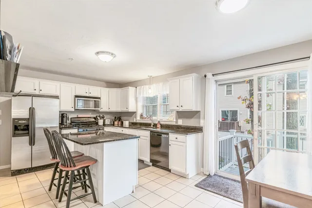 a kitchen that has a lot of cabinets in it and appliances
