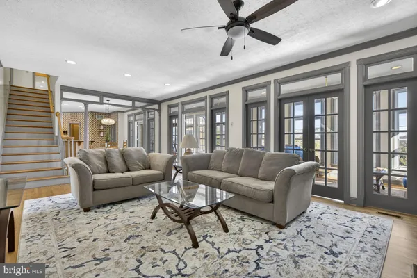 a kitchen with stainless steel appliances granite countertop wooden cabinets a sink dishwasher a stove and a refrigerator with wooden floor