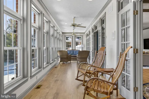 a kitchen with stainless steel appliances granite countertop a refrigerator a sink dishwasher a stove top oven a refrigerator with island and chairs with wooden floor