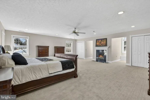 a view of an empty room with a fireplace and a window