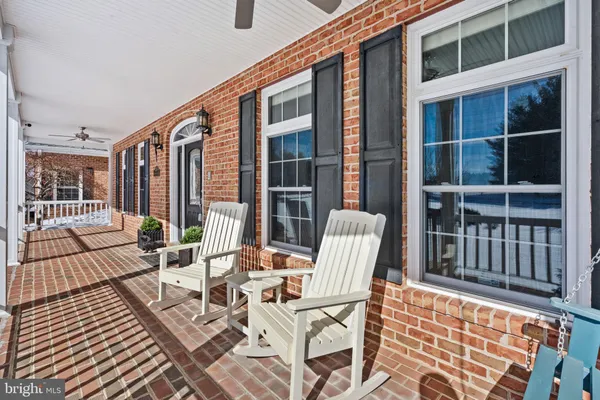 a view of a balcony with wooden floor and furniture