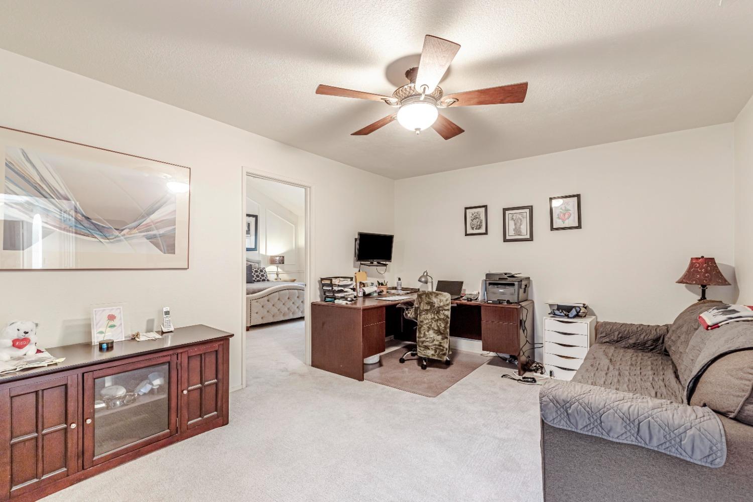 4 Seasons Court Madera, CA 93637 - Photo 11 of 18 a living room with furniture and a flat screen tv