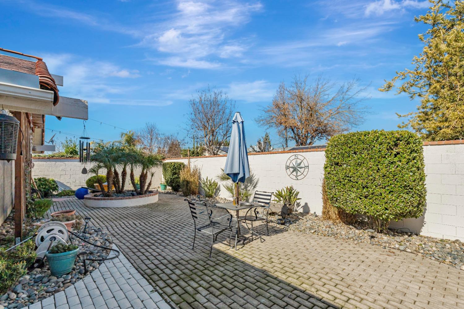 4 Seasons Court Madera, CA 93637 - Photo 15 of 18 a view of a patio with table and chairs potted plants with wooden floor and fence