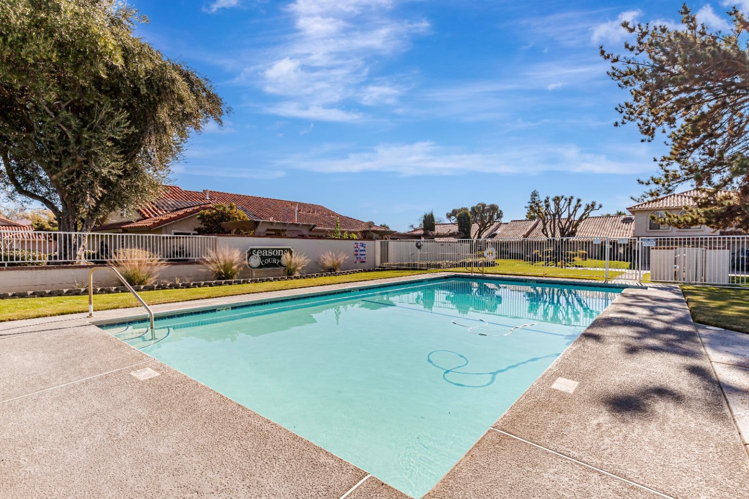 4 Seasons Court Madera, CA 93637 - Photo 16 of 18 a view of swimming pool with outdoor seating and city view