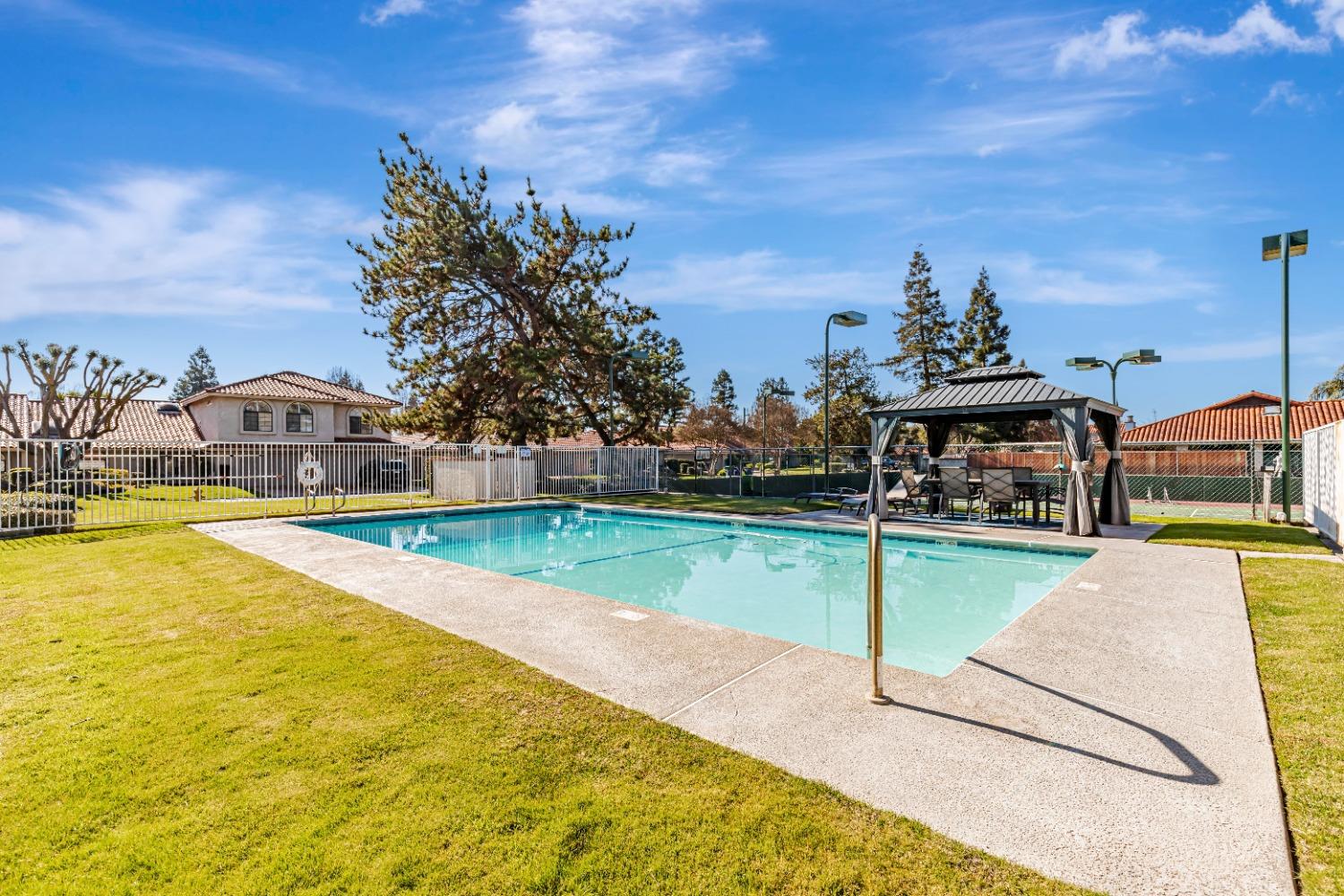 4 Seasons Court Madera, CA 93637 - Photo 17 of 18 a view of a swimming pool with a yard