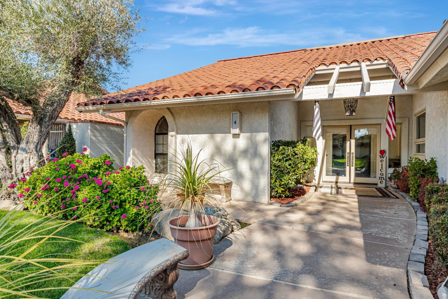 4 Seasons Court Madera, CA 93637 - Photo 2 of 18 a front view of a house with garden