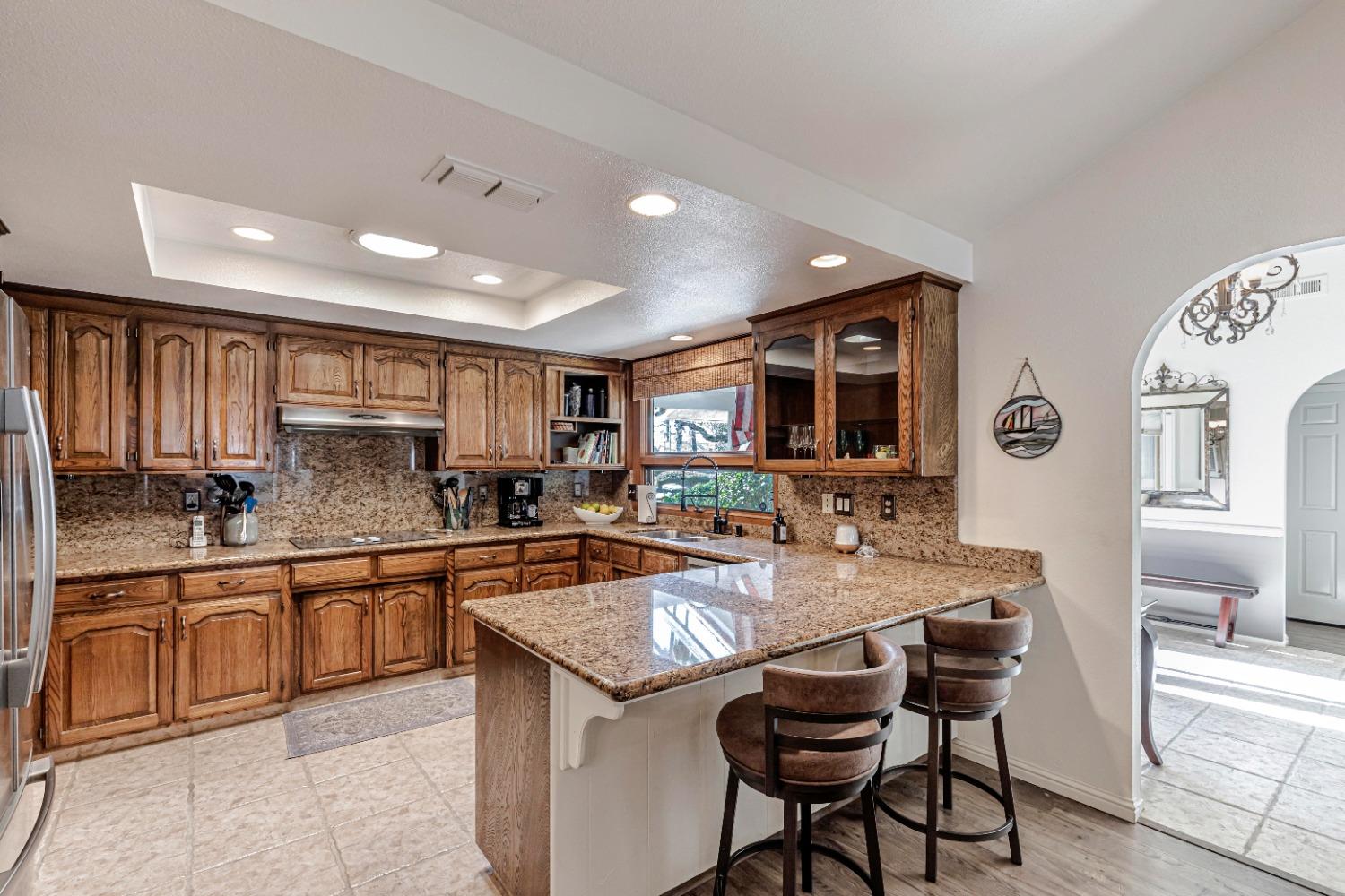 4 Seasons Court Madera, CA 93637 - Photo 3 of 18 a kitchen with granite countertop kitchen island stainless steel appliances a sink and cabinets