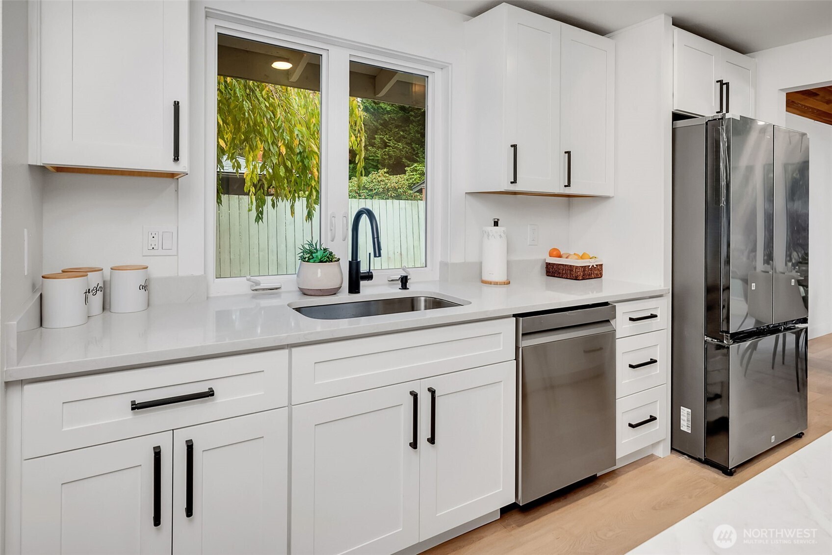 16123 Southeast 146th Place Renton, WA 98059 - Photo 15 of 40 a kitchen with appliances a sink a counter and cabinets